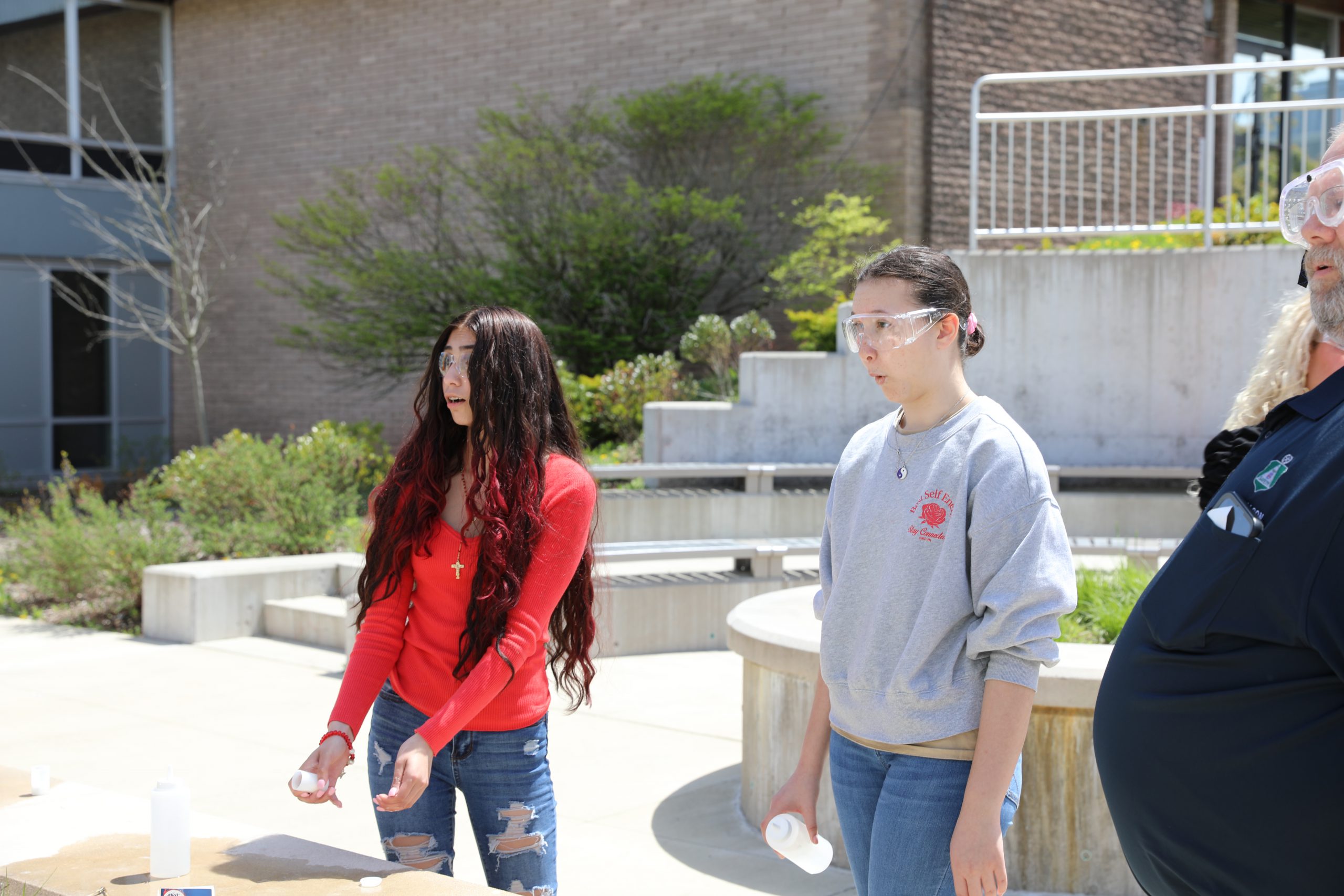 two students are looking up in surprise after launching a rocket