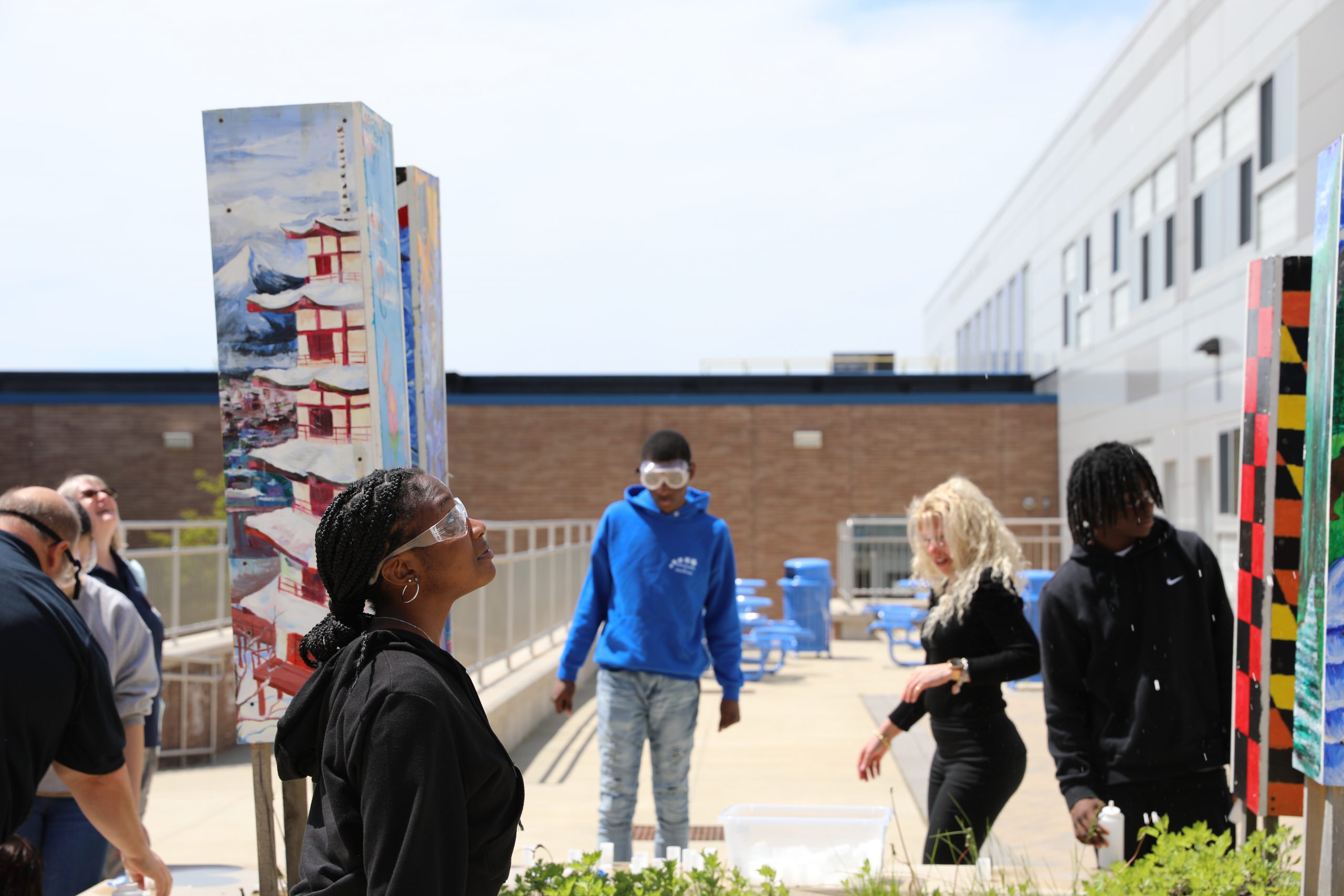 students look skyward at the rockets they launched. 