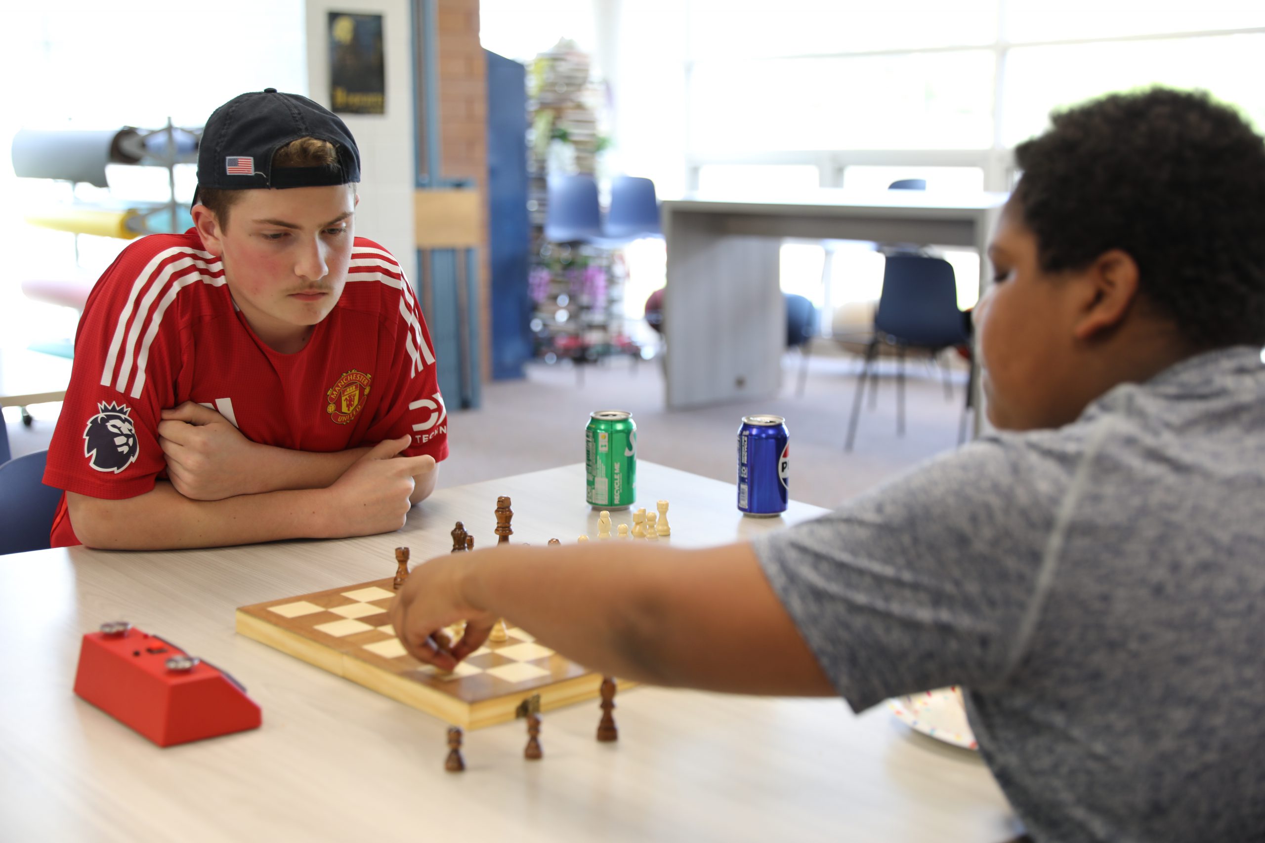 two students are engaged in a game of chess 