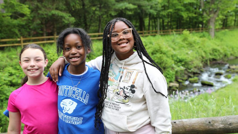 three students pose by the canal
