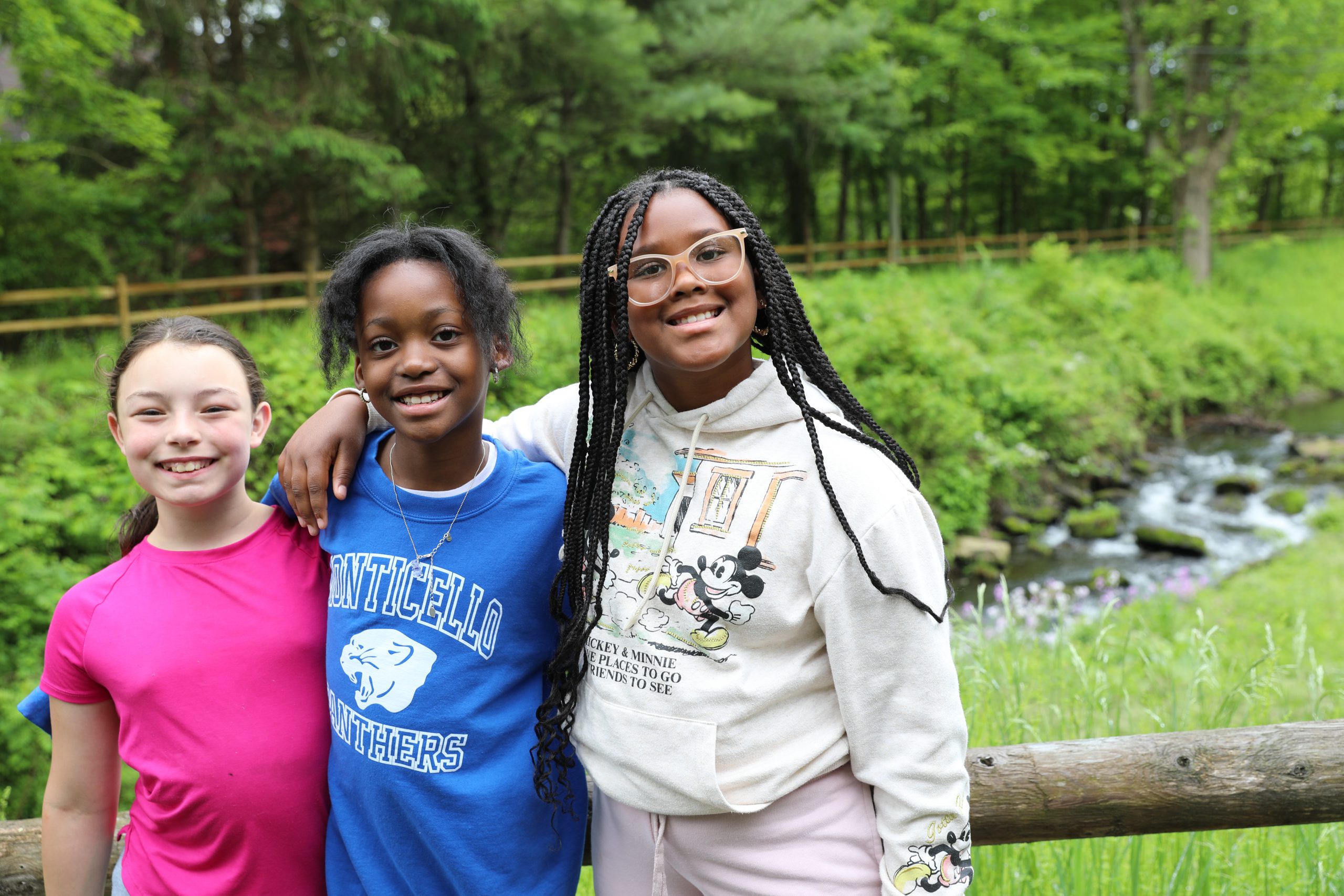 three students pose by the canal 