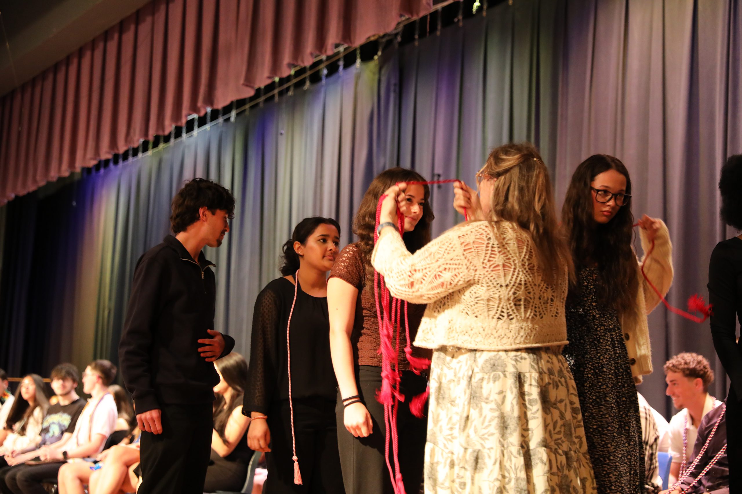 a student is having a cord placed on her