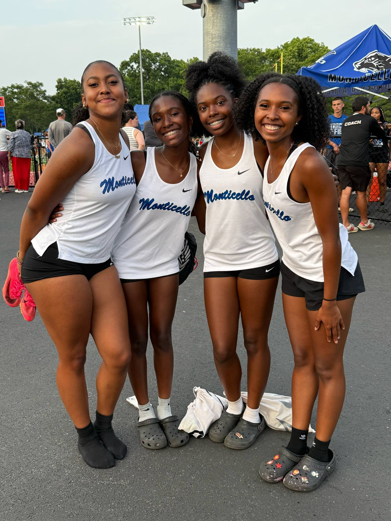 Four of the state qualifers are posing in track uniforms 