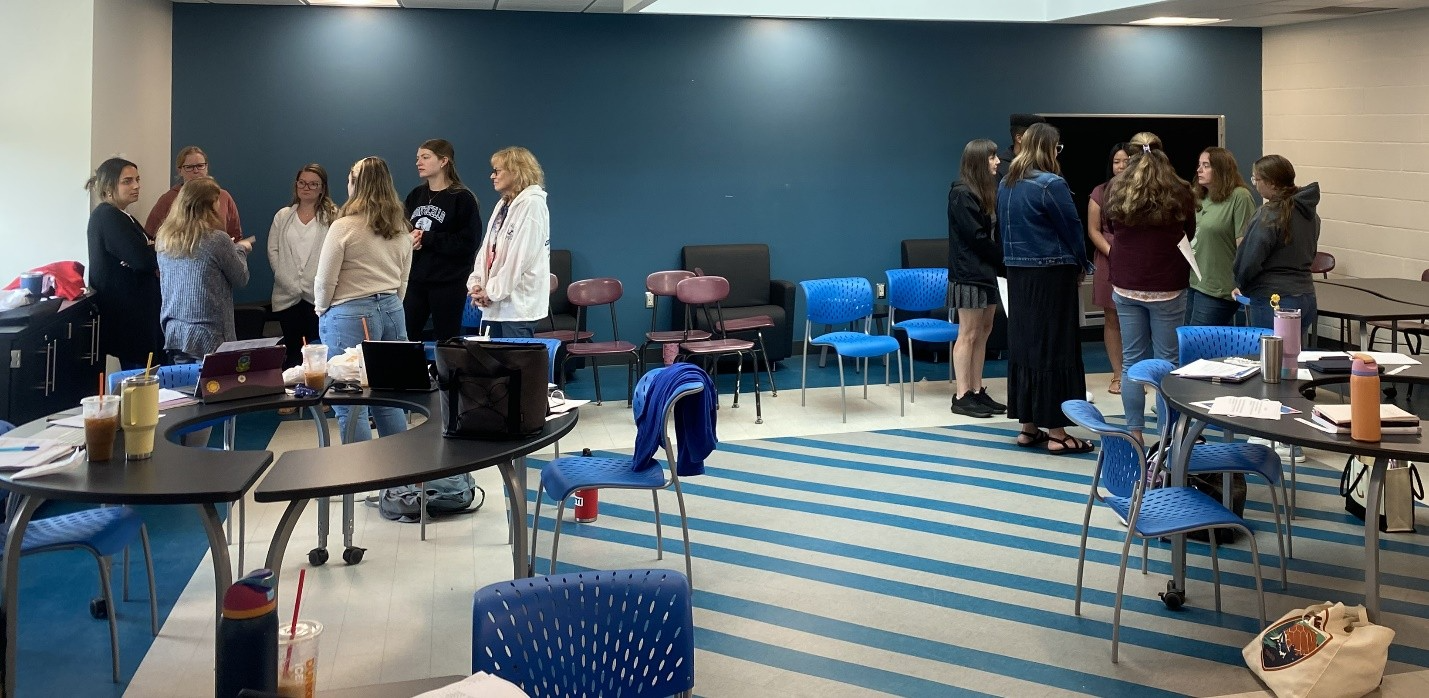 a group of teachers are in a room 
