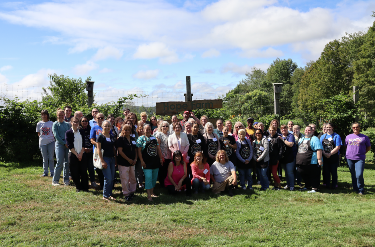 a group of food service staff pose during a conference