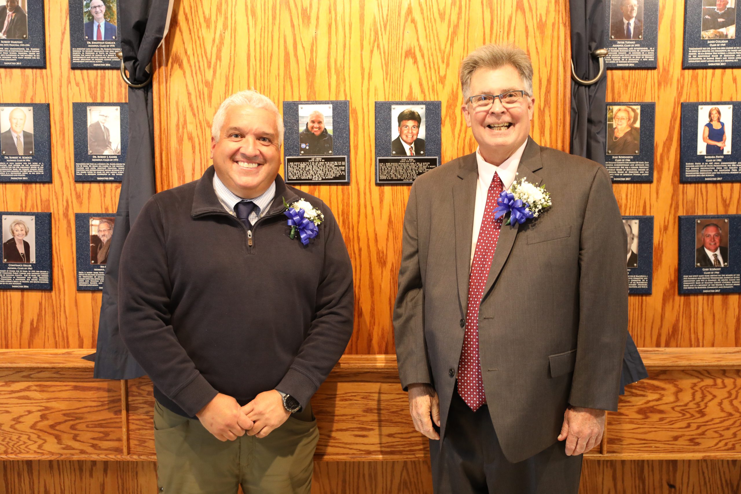 Alex Cabrero, left, and Daniel L. Briggs, right, stand in front of their plaques