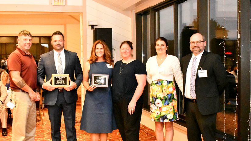 Ryan Jasper, Heather Fassell and admins from the district pose during the dinner.