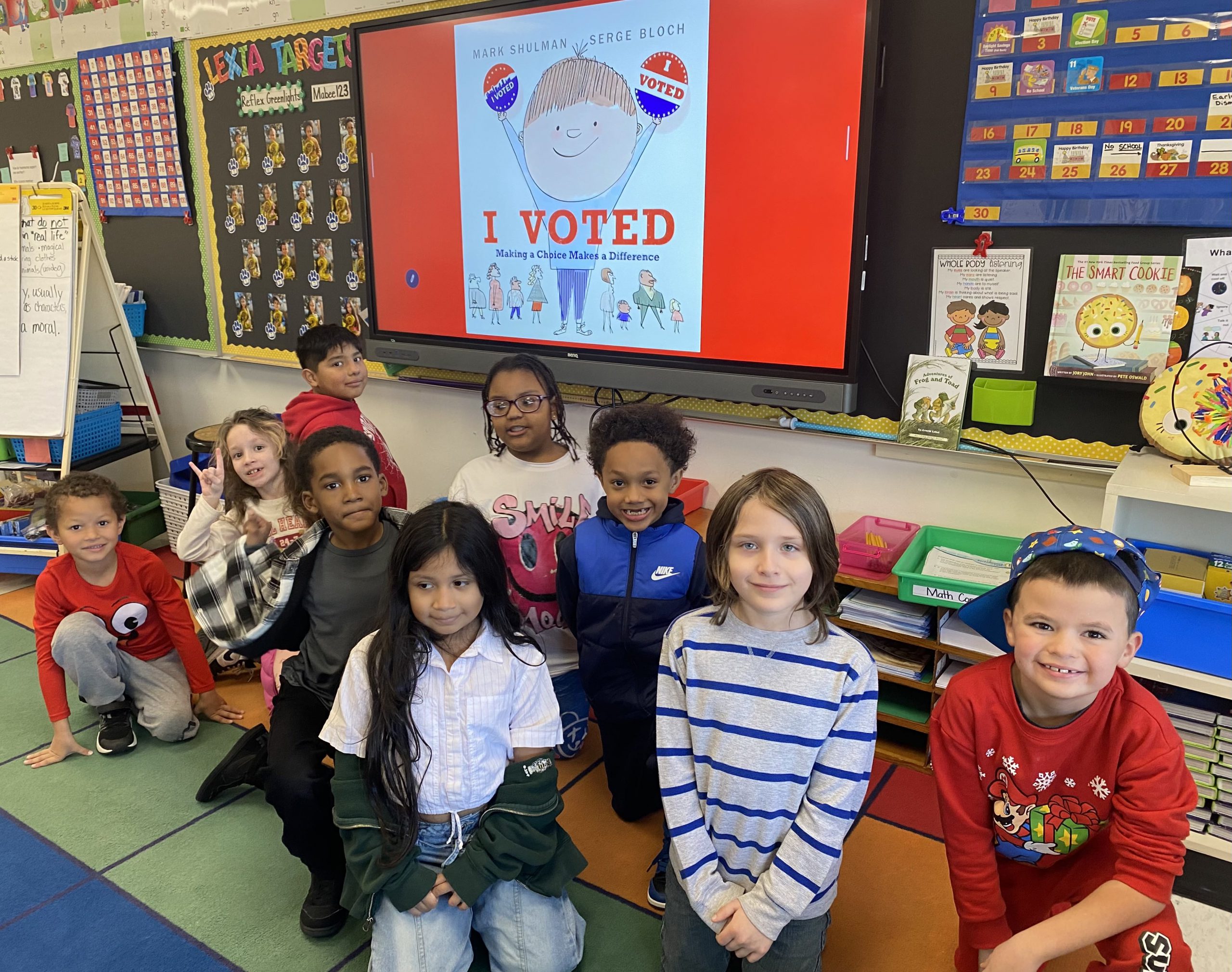 a group of students are posing behind an I Voted banner