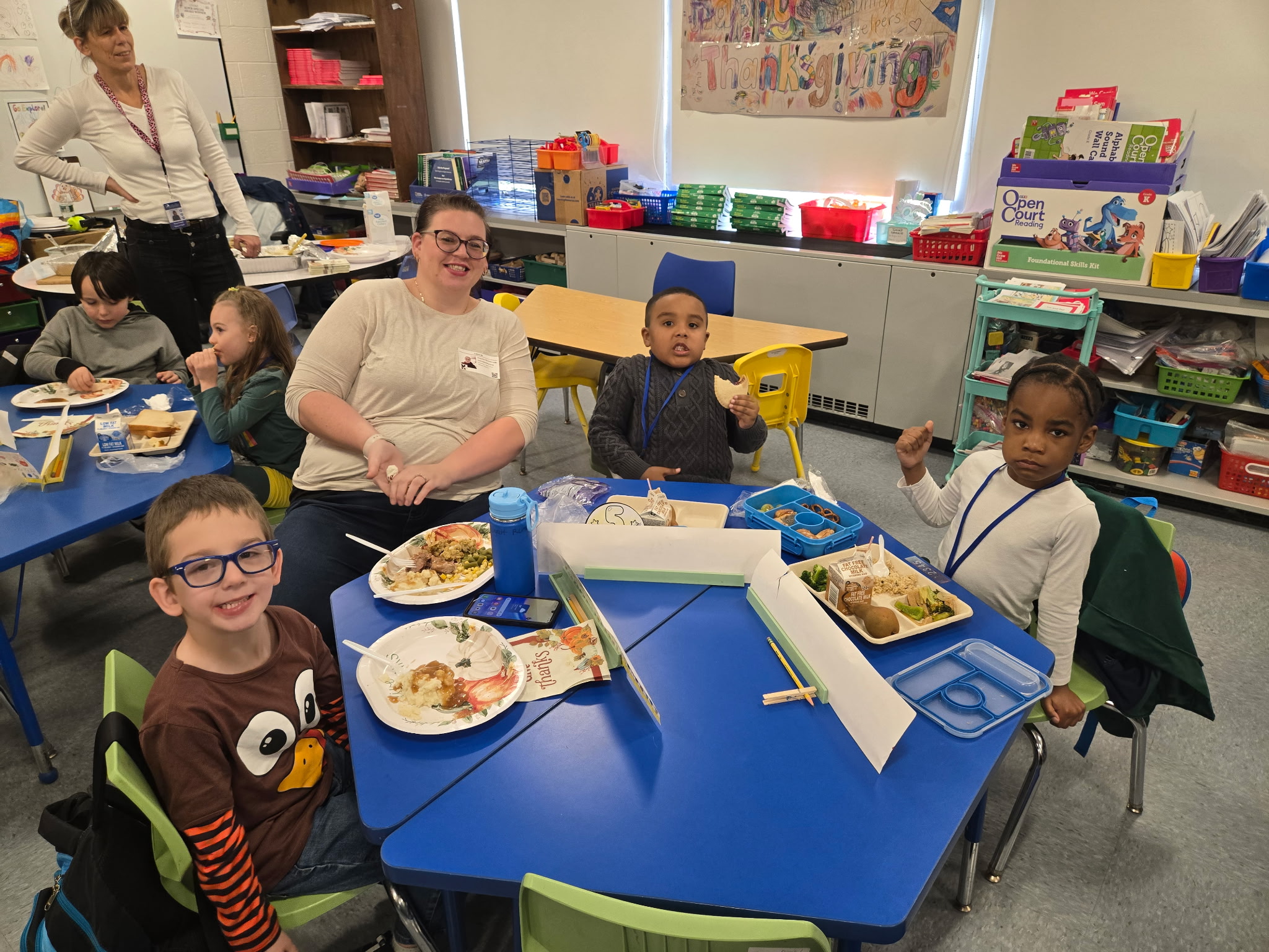 a group of students eat around a table
