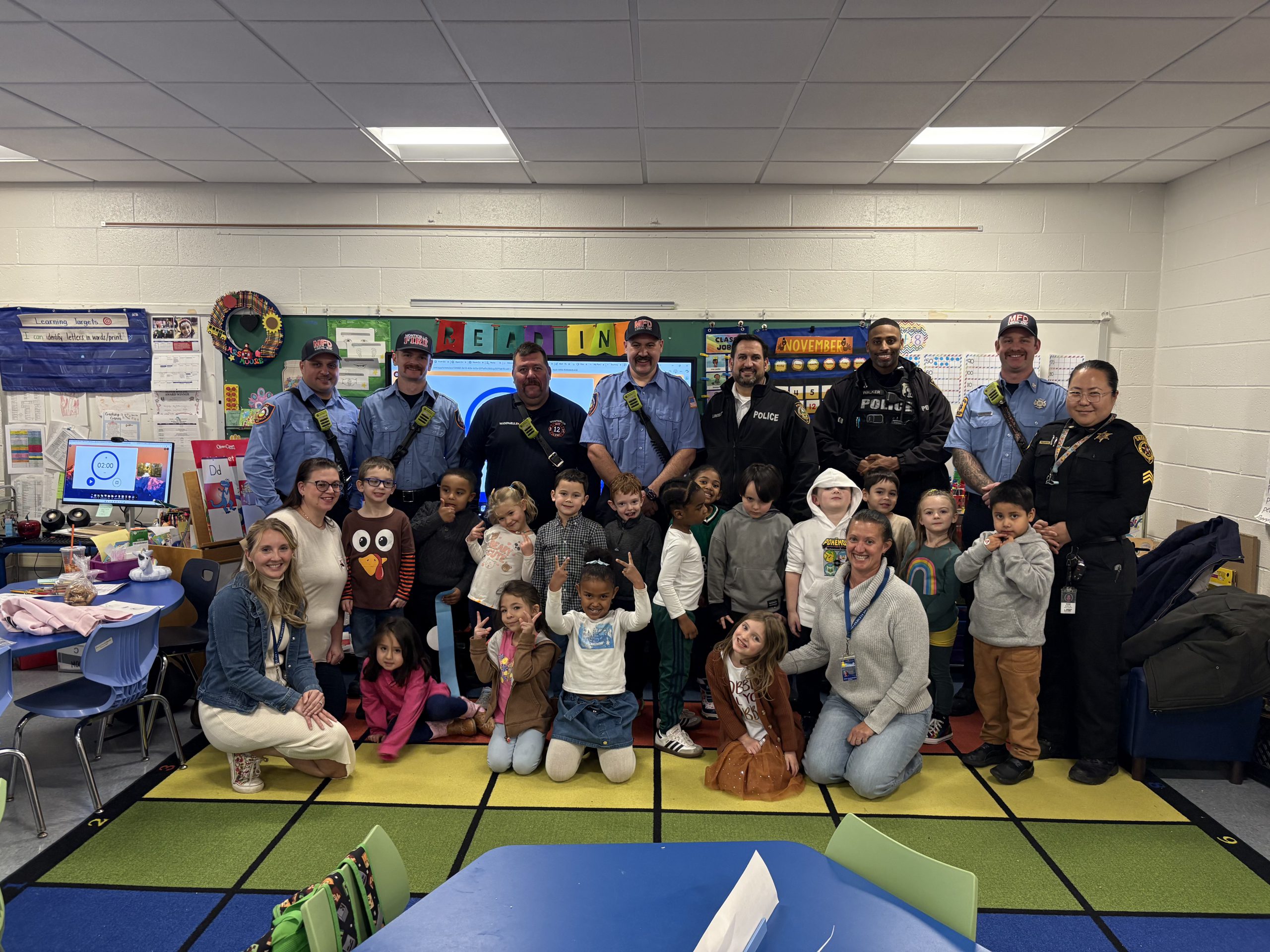a group of students pose with firefighters and first responders