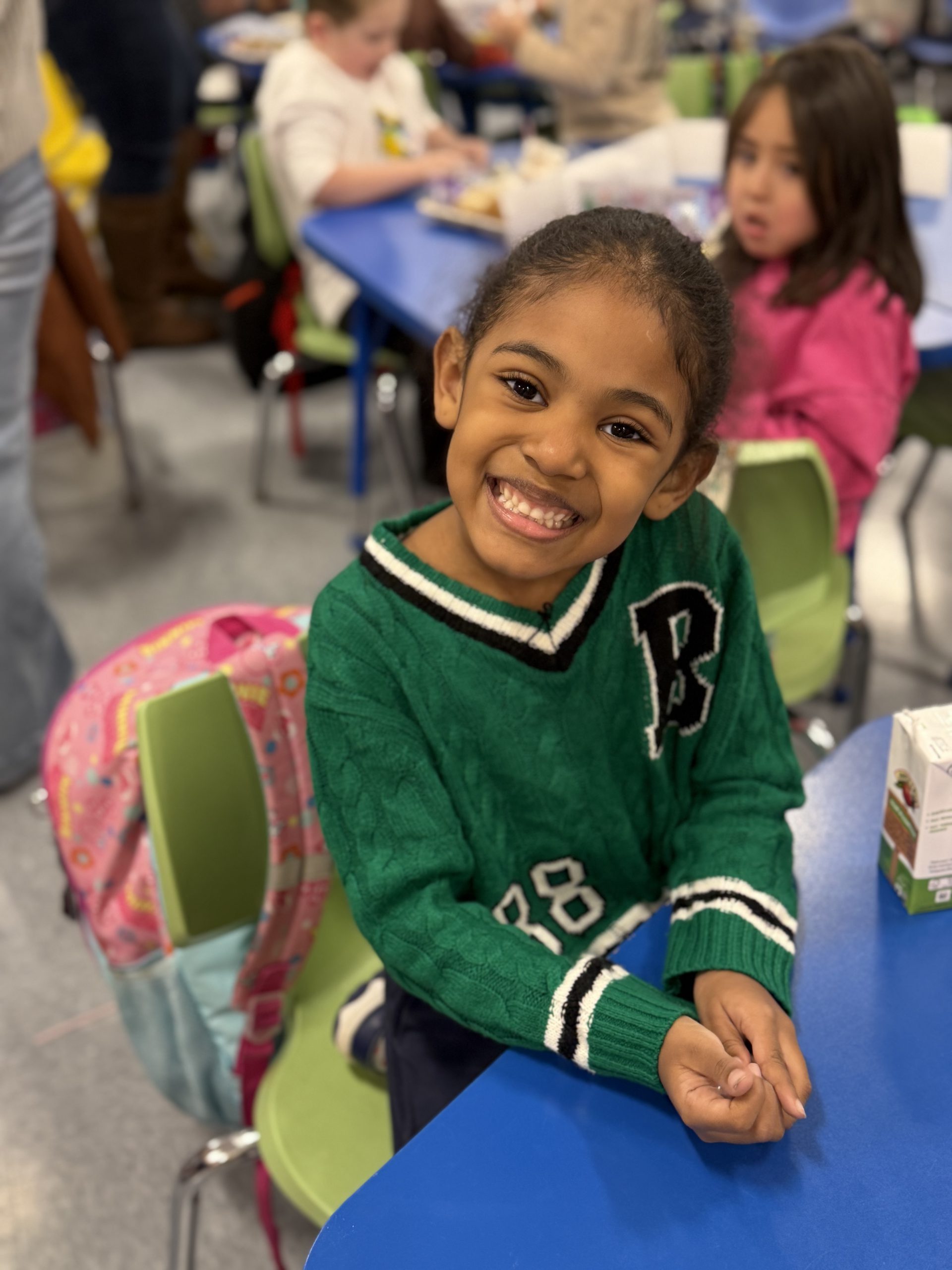 a student is smiling at a chair