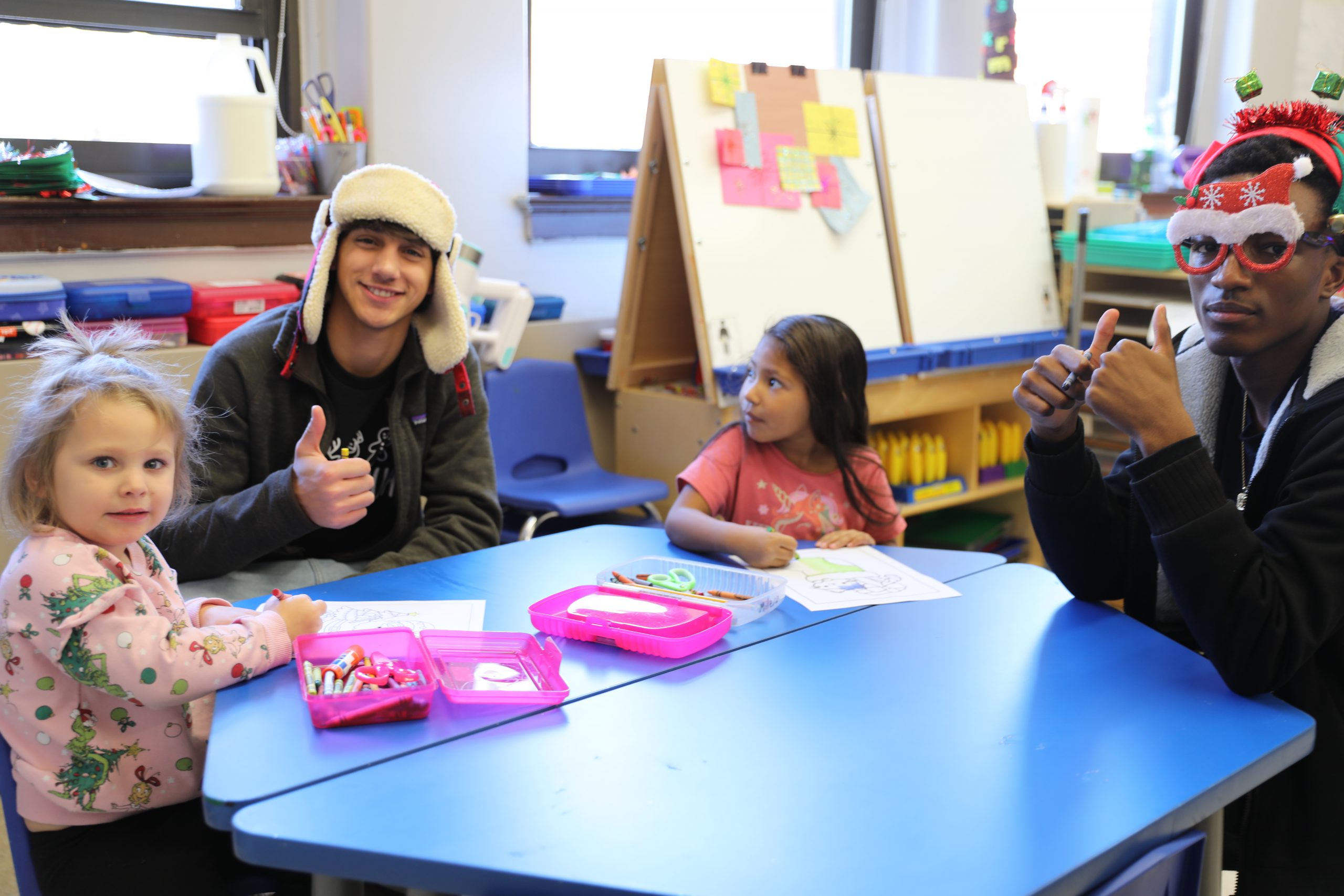 students are seated at a table engaged in an activity