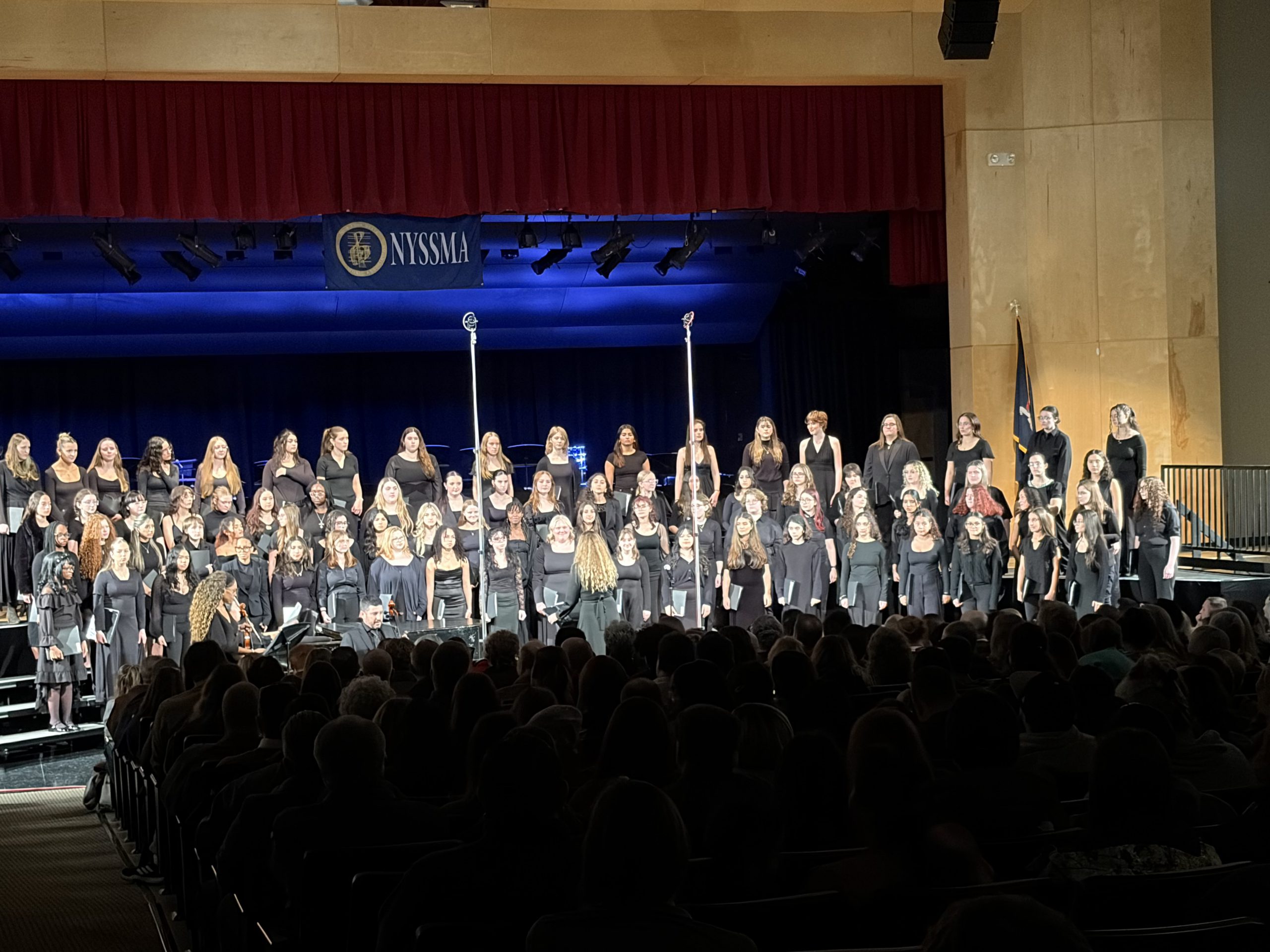 The area all state chorus on stage performing