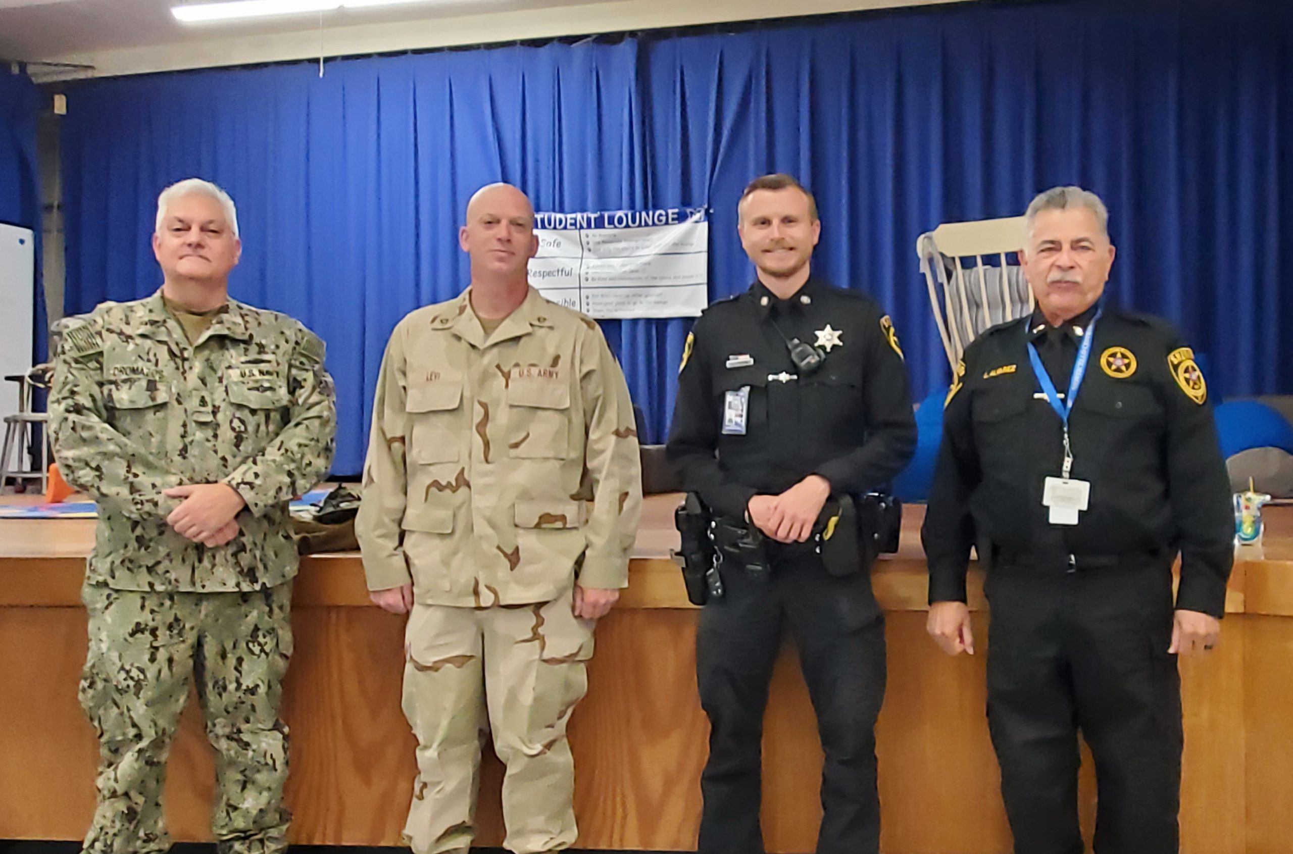 four veterans pose in the KLR cafeteria