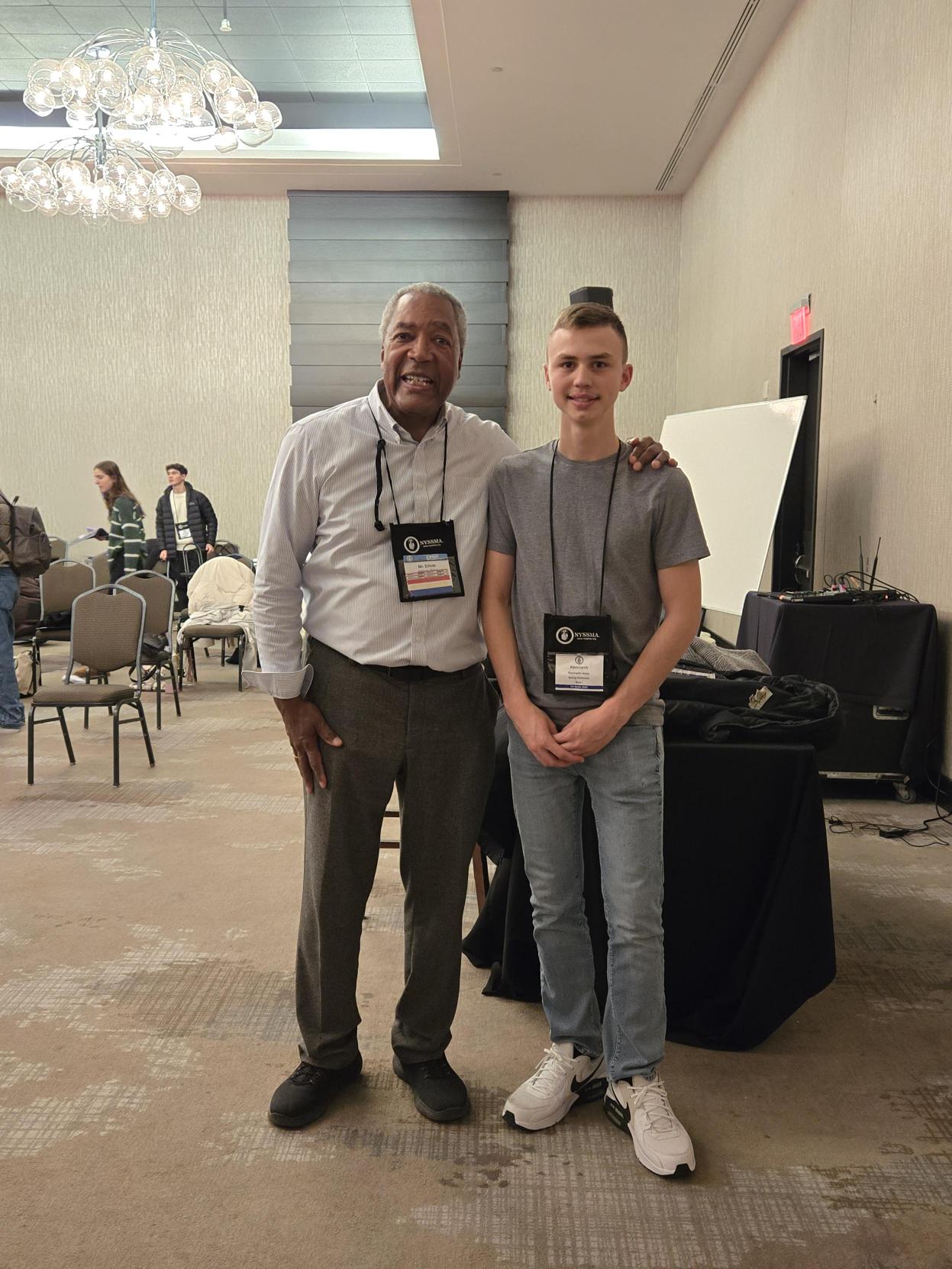 Kenny poses with a teacher