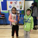 two students hold up a trophy