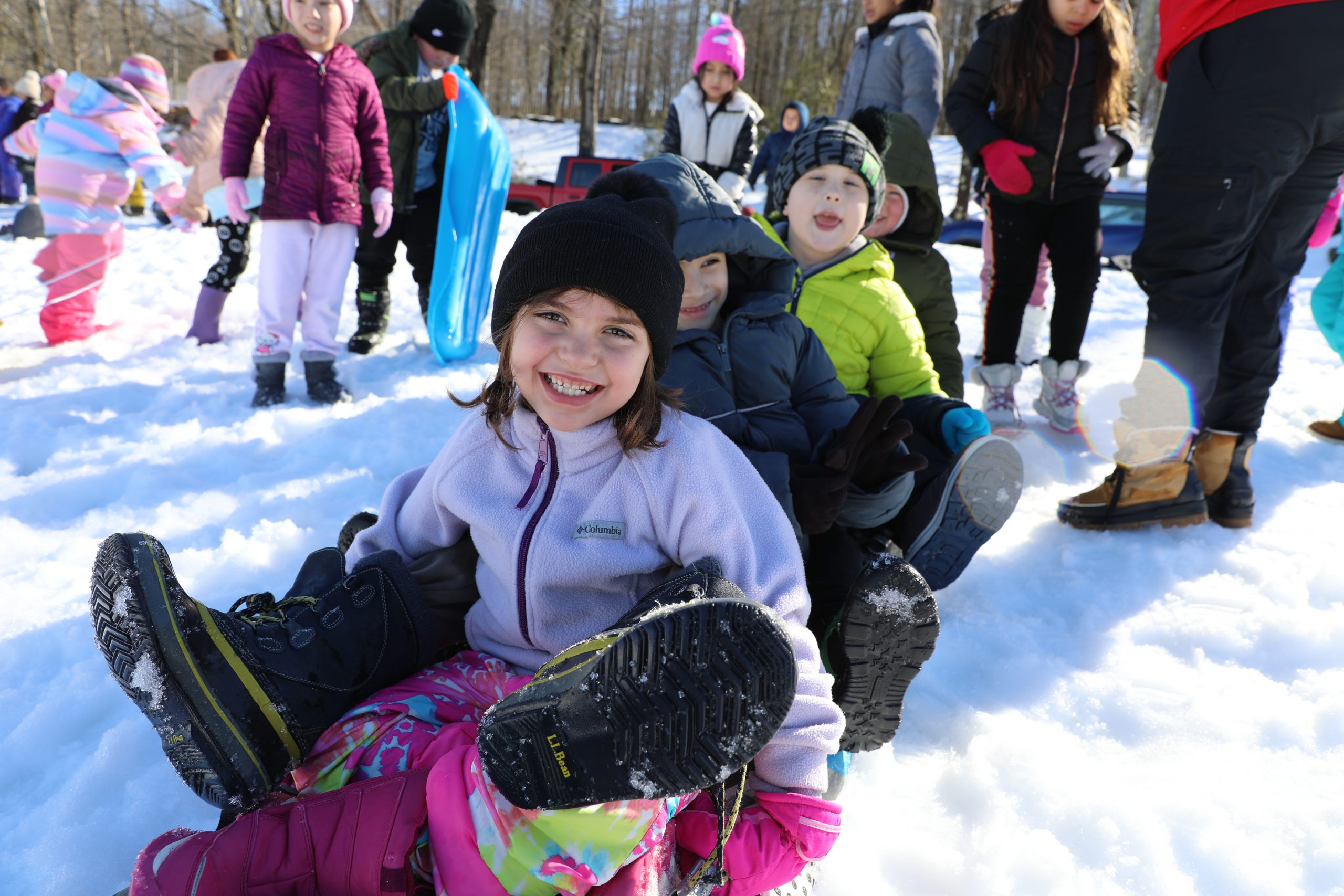 a group of students is about to sled down a hill 