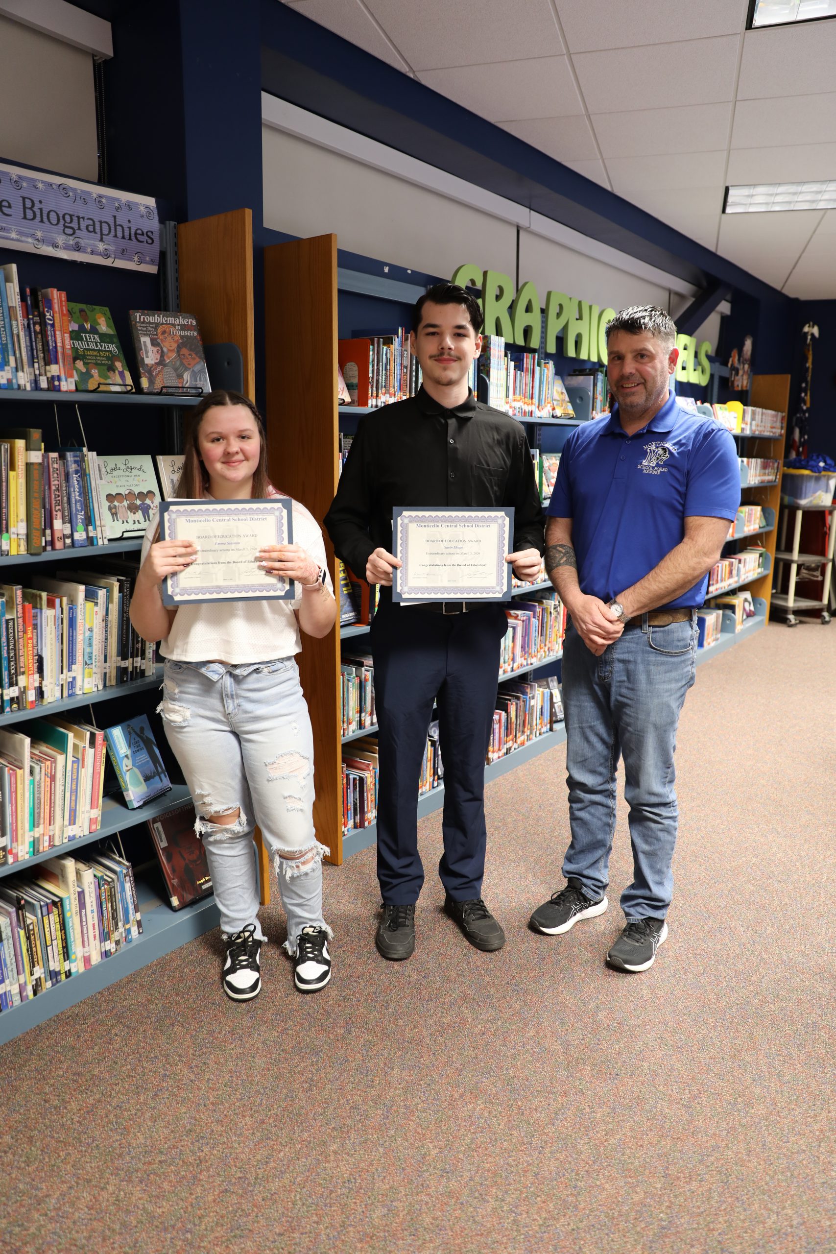 Emma and Gavin pose with Board President Tim Crumley