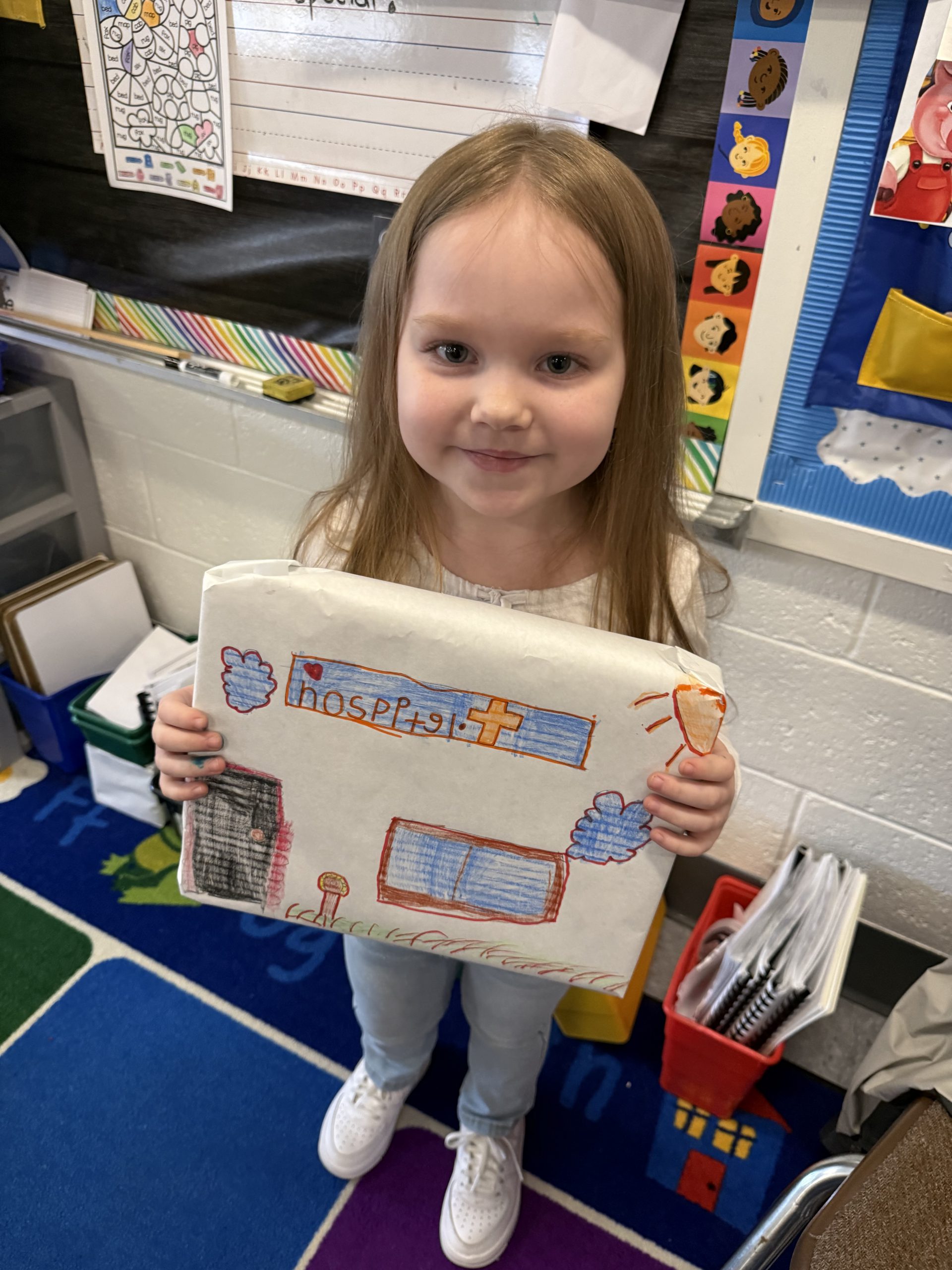 a student holds up her completed box top project