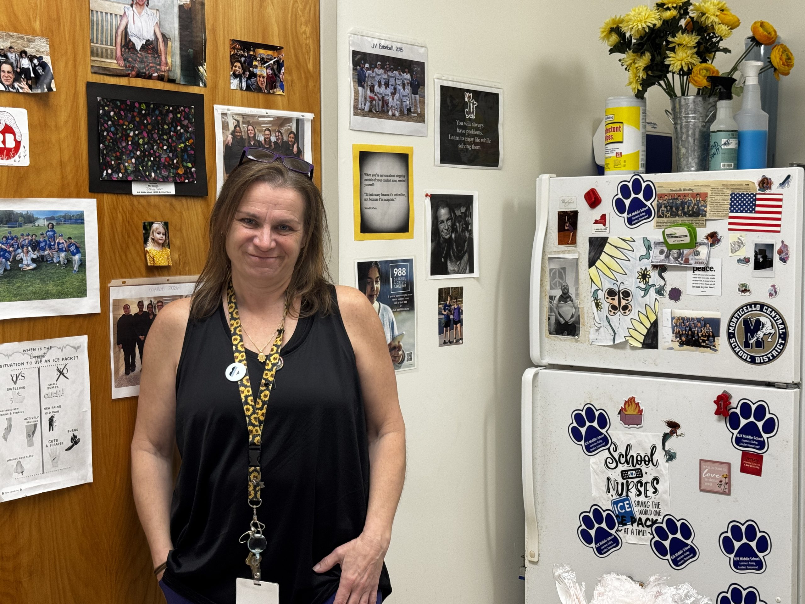 Nurse Kim Webakowsky stands in her office smiling