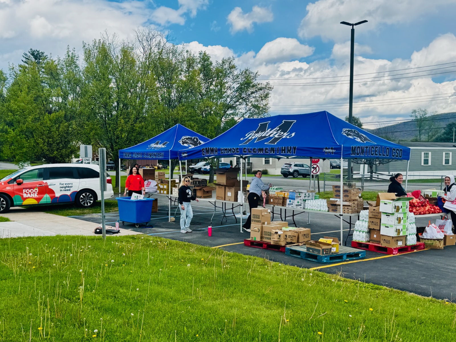 tent set up in Chase parking lot with boxes of food waiting for distribtion