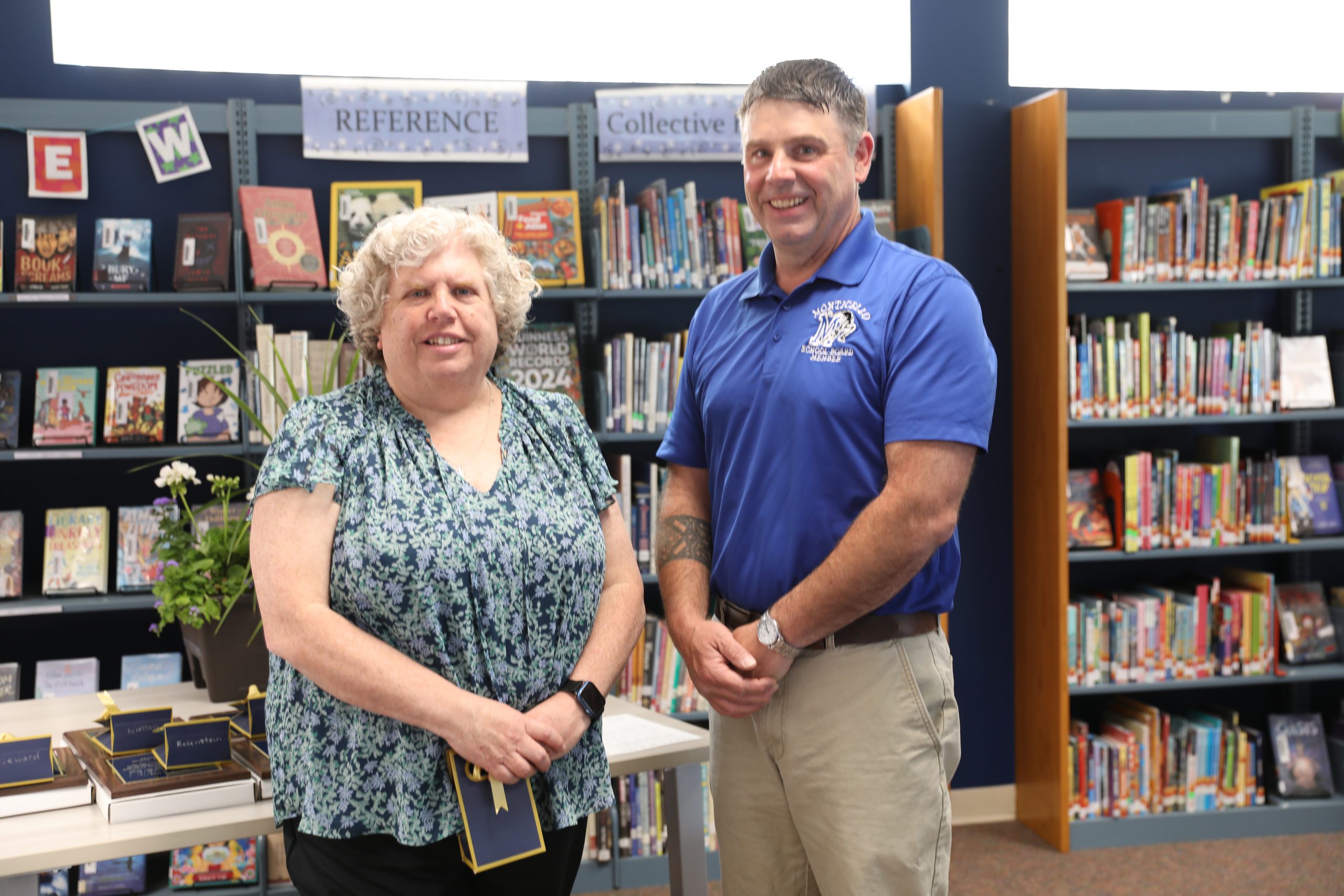 Patricia Andersen is posing for the camera with President Tim Crumley 