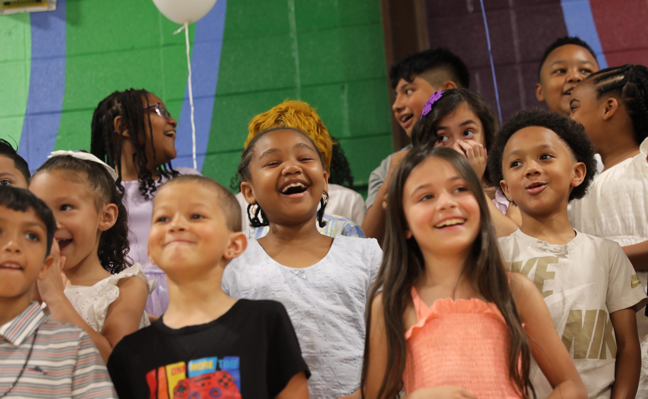 a group of students singing on stage 