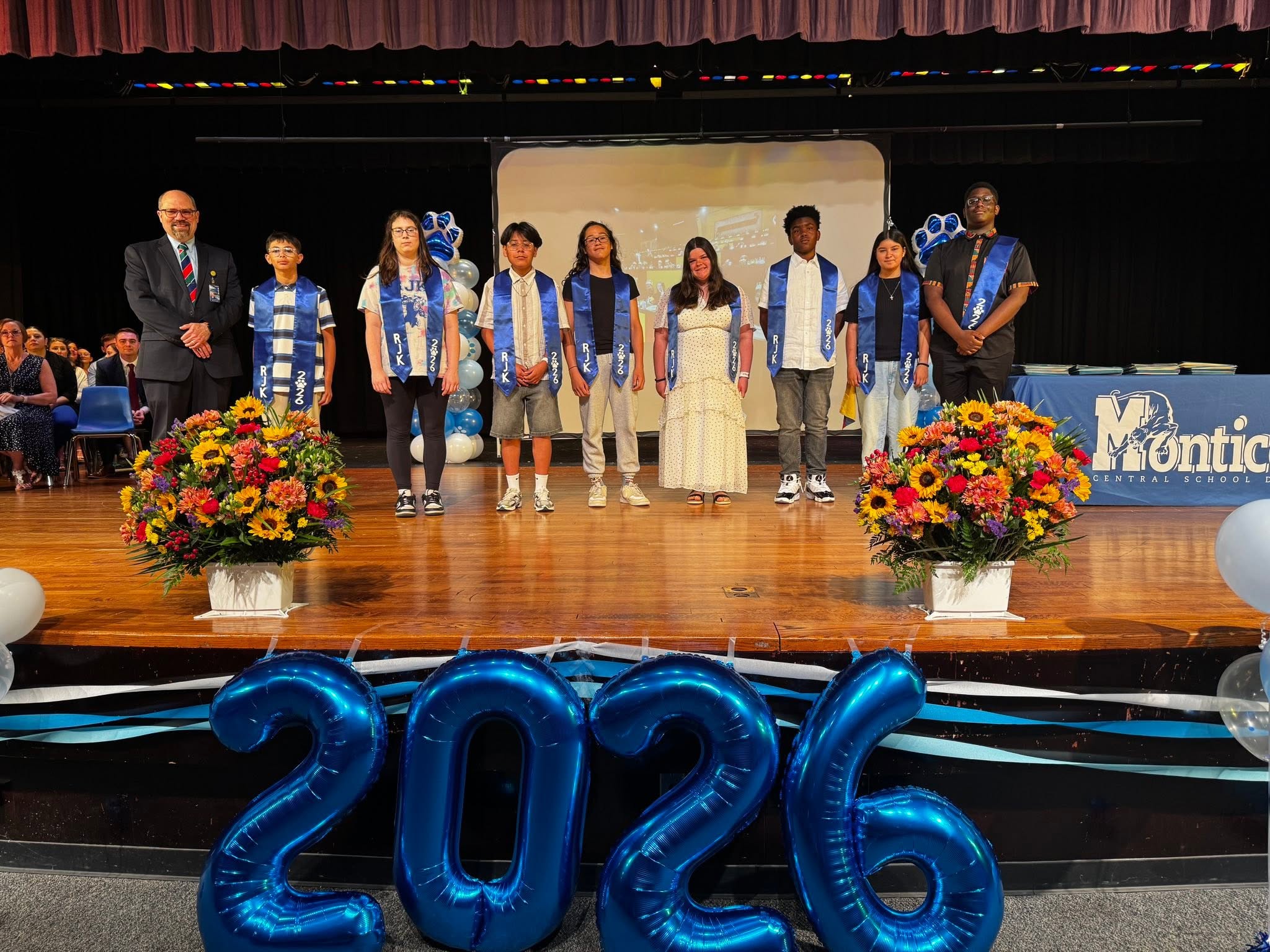 students who earned the presidential achievement award gather on stage