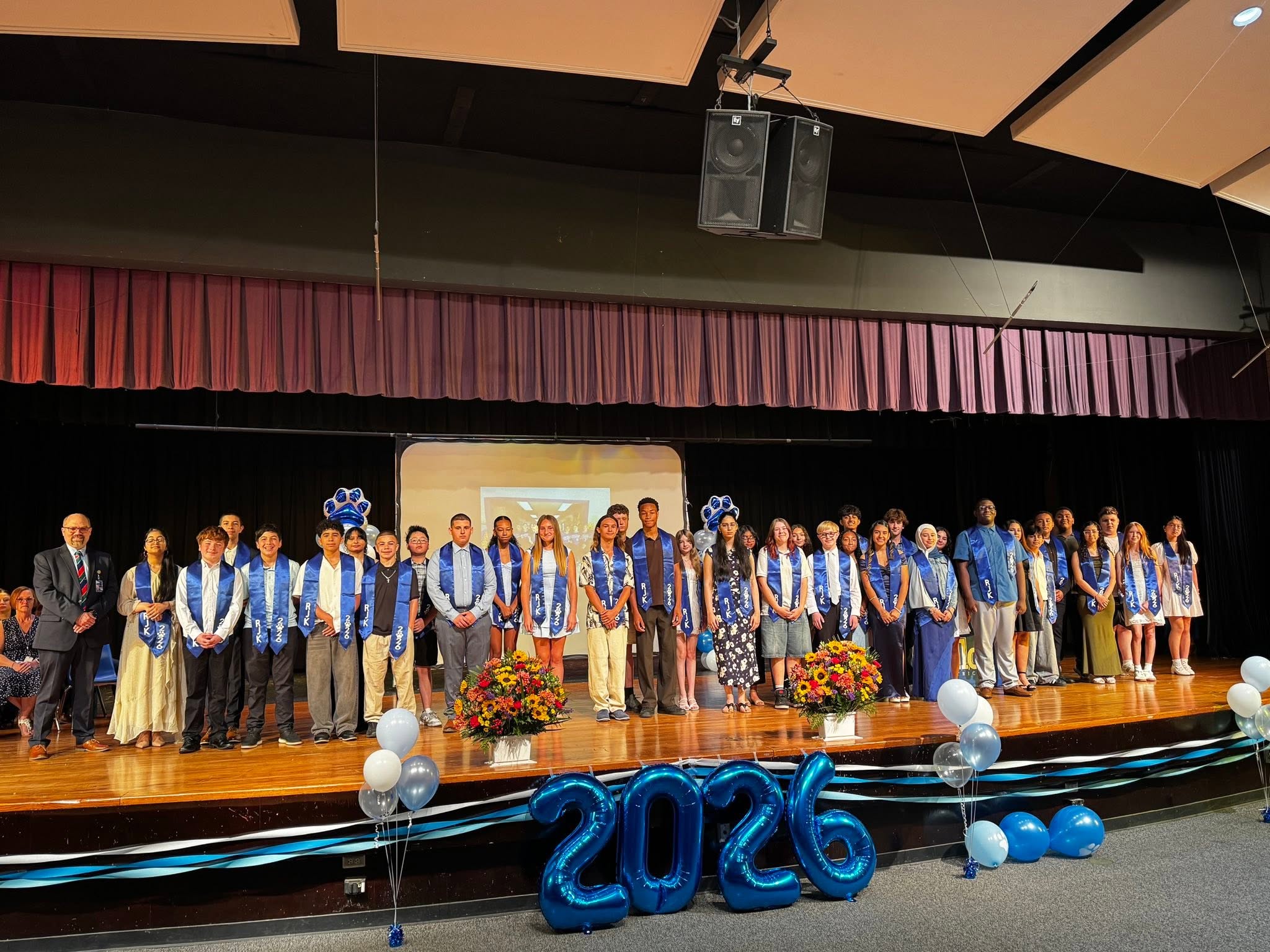 students who earned the Presidential Award for Excellence gather on stage