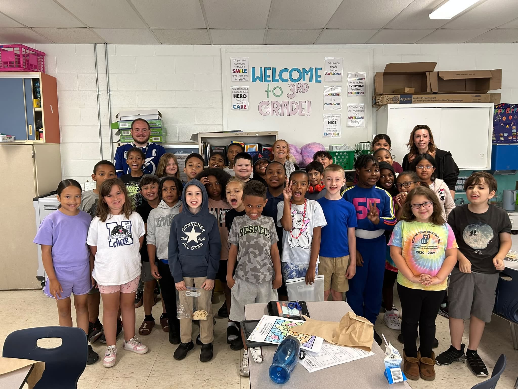 the class poses at the front of the room 