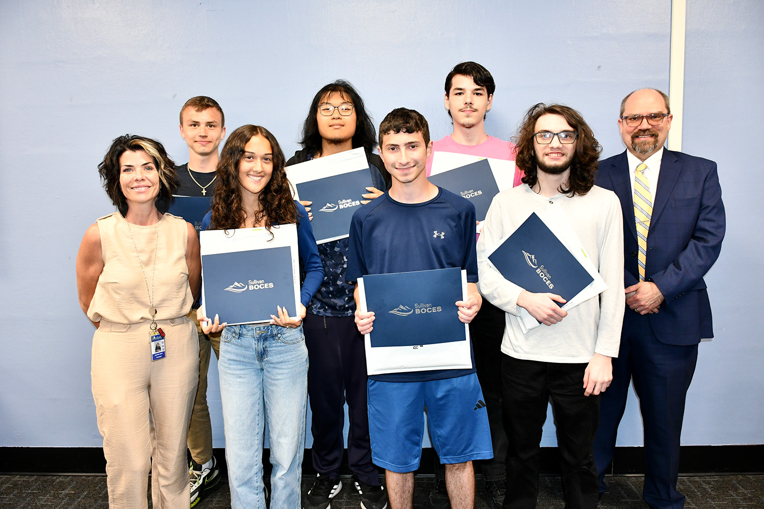 Some of the students from the academic achievement ceremony post with the principal and superintendent