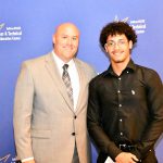 a CTE student poses with their award at the banquet