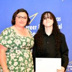 a CTE student poses with their award at the ceremony
