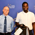 a CTE student poses with their award at the ceremony