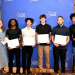 a CTE student poses with their award at the ceremony