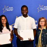 a CTE student poses with their award