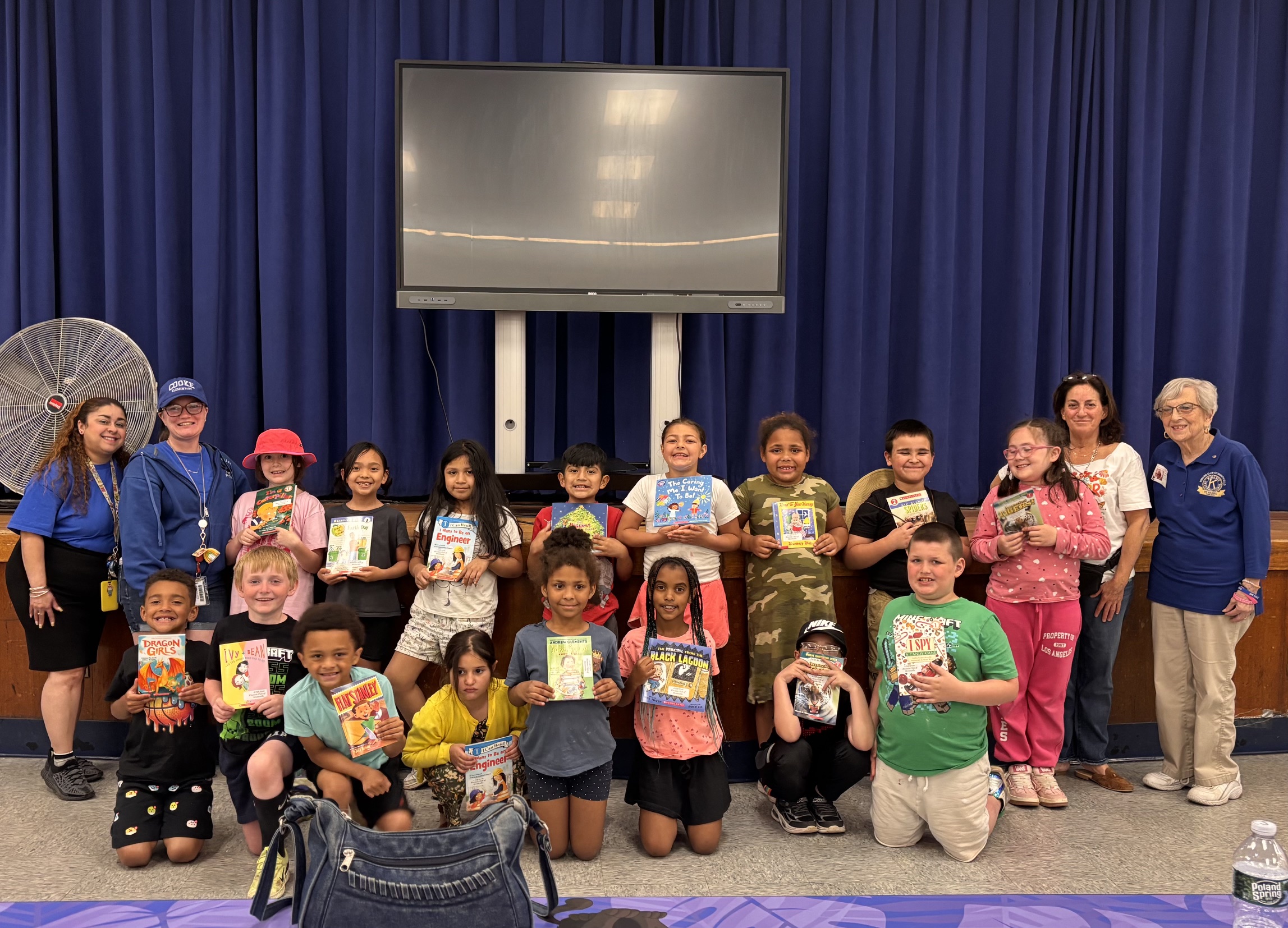 a group of students are posing with the books they received from the Kiwanis club