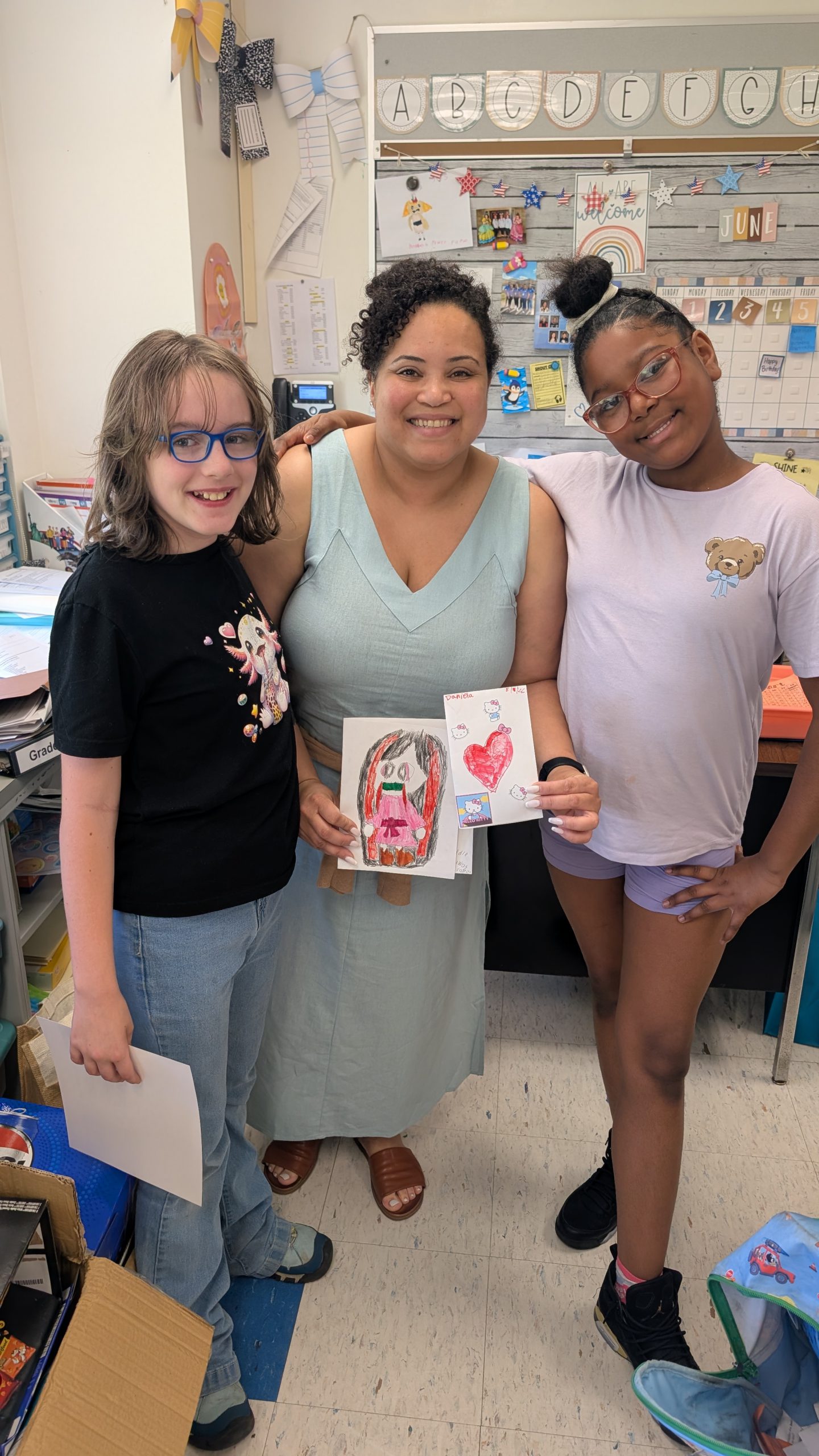 two students pose with the program's facilitator 