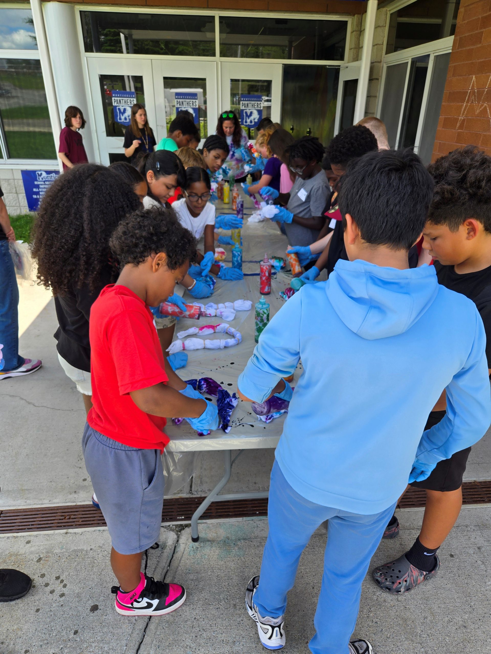 a group of students work on a craft at a table