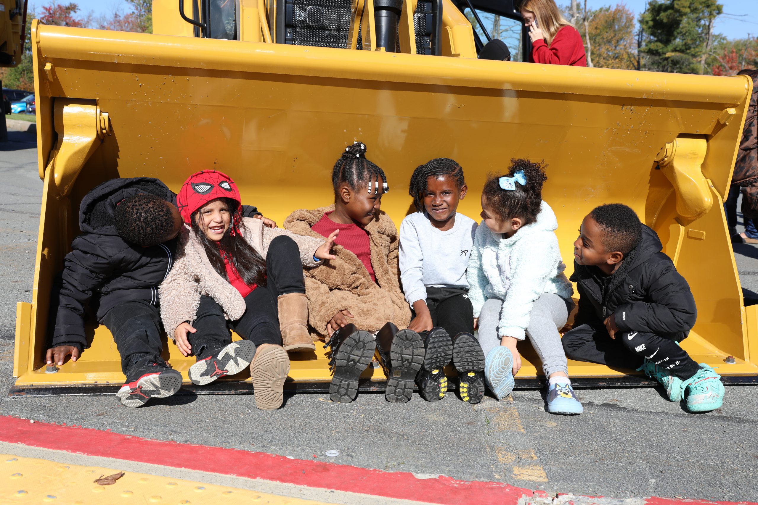 students laugh while seated in a truck during touch a truck day 